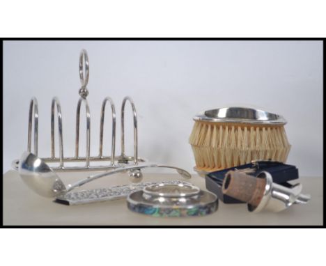 A collection of silver and silver plated items to include a continental silver comb holder, a pair of silver hallmarked brush