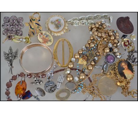 A collection of vintage and retro costume to include brooches, necklaces, earrings, cuff links etc.
