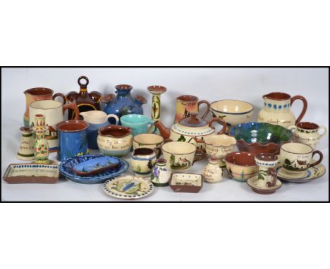 A large collection of Devon / Cornish torquay ware / mottoware ceramic pottery jugs and other similar pottery to include vari