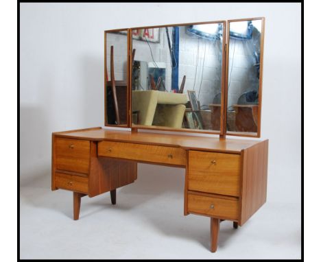 A vintage mid 20th century teak wood dressing table by Youngers and Sons. Triptych mirrors to the top with twin drawers to bo