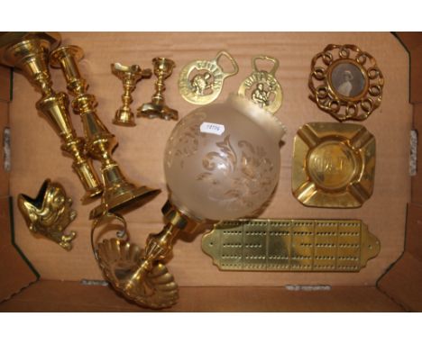 A collection of brassware items to include Chamber stick holder and shade, Brass Crib Board, Candle Sticks, Brass Spoon warme