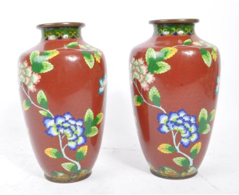 Two matching 20th Century Republic period export enamel Chinese vases of dark red ground with a floral splay of vibrant yello