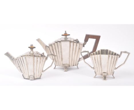 An early 20th Century 1920s vintage Art Deco silver plated three piece tea service of geometric / fan shaped design upon four