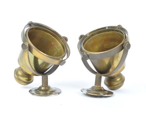 A pair of ships brass double gimbal candlestick sconces. The sconces each having rounded backplates, extending to a bi-axis g