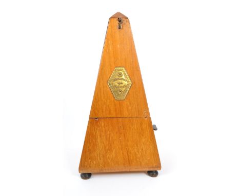 Maelzel - An early 20th Century walnut metronome case with removable door to reveal the tempo scale and pendulum bar. Plate t