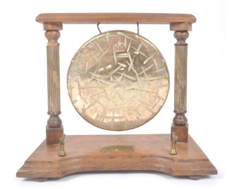 A vintage 20th century brass Burmese table gong mounted on wooden base / frame. Having metal shield tag to base with pillar s