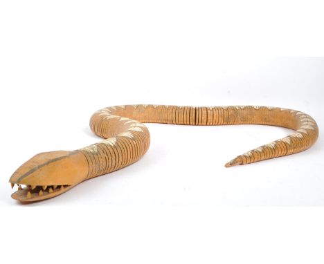 A vintage 20th Century painted wooden articulated snake. The figure in the form of a snake with hand painted scale decoration