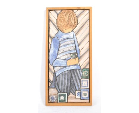 A vintage 1970s ceramic wall plaque by Sheila Stapleton. Plaque depicting a young girl picking stylised flowers. Framed and s
