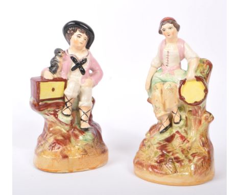 A pair of 19th century Victorian Staffordshire ceramic figures. Comprising of Organ Grinder little boy with his pet monkey, w