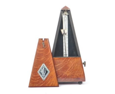 Maelzel - A mid 20th century German metronome. With hinged door opening to reveal the tempo pendulum with weight. In pyramid 