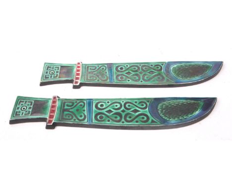 Poole - A pair of mid Century 1960s ceramic glazed Poole pottery Richard Jefferson wall plaques in the form of daggers in dar
