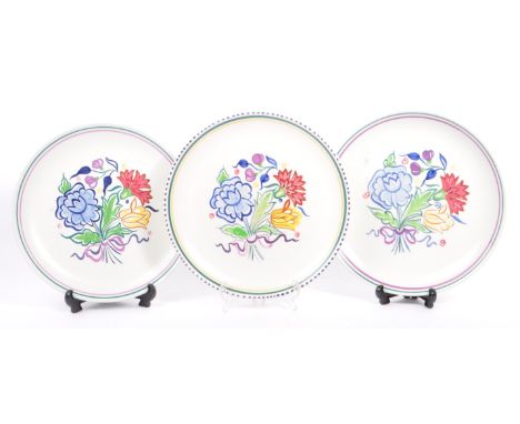 Poole Pottery - A collection of three ceramic pottery display plates. With polychrome floral and foliate decoration in a whit