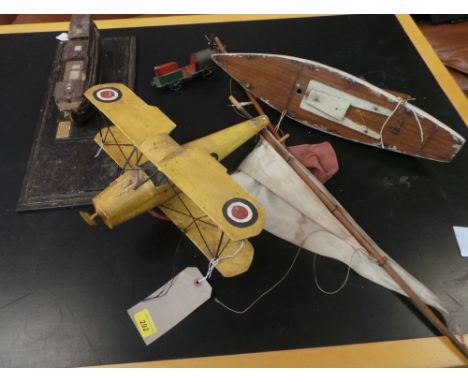 A collection of model boats and a tin plate biplane and an early tinplate train