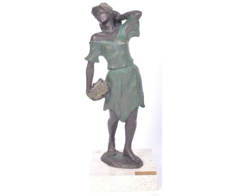 A vintage 20th century hand painted resin statue in the form of a female figure wearing dress and holding a basket of flowers