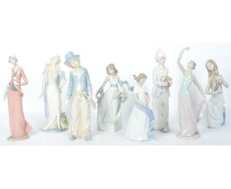 An assortment of eight vintage 20th century Nao by Lladro porcelain figurines to include girl brushing her hair, girl dancing