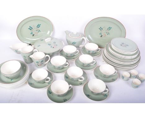 A part vintage 20th century Poole Pottery dinner service in the pattern of "Leaping Deer" on light green background. The lot 