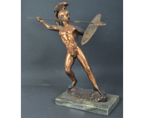 A vintage gilt metal Leonidas King of Sparta statue holding spear &amp; shield standing over a marble plinth.&nbsp;