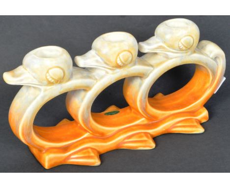 A vintage circa. 1930's Art Deco era Beswick china candlestick candle holder in the form of a row of three stylized ducks. St