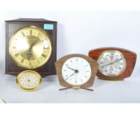 An assortment of vintage retro mid 20th century clocks to include a formica type mantel clock, Bentima mantle clock, a Peter 