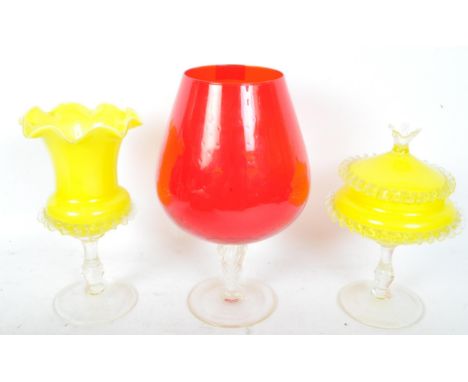 A collection of 20th century coloured studio art glass to include red brandy glass, tapering stem vases, yellow bon bon dish,