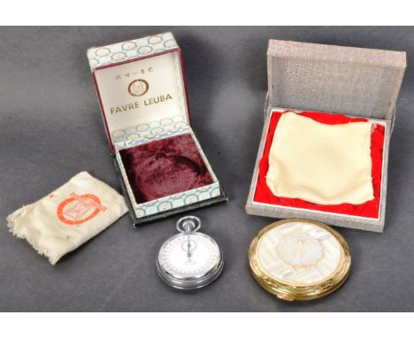 A vintage mid 20th Century mother of pearl set compact. The compact of round form having an applied peacock to the front and 