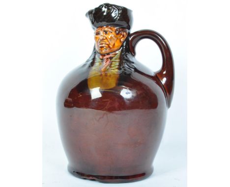 An early 20th century Royal Doulton Kingsware polychrome glazed whiskey flagon of Bill Sykes relief moulded features with tra