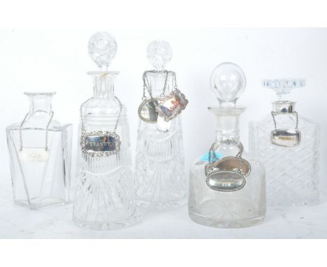 A collection of five vintage 20th century cut crystal glass decanters having etched lattice work motifs and more. All with st