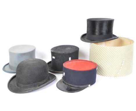 A collection of vintage 20th century hats to include a French policemans hat, top hat, bowler hat, and more.&nbsp;
