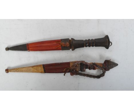 A vintage 20th Century pair of African tribal knives / daggers. With leather covers and hand made handles. Measures approx. 3