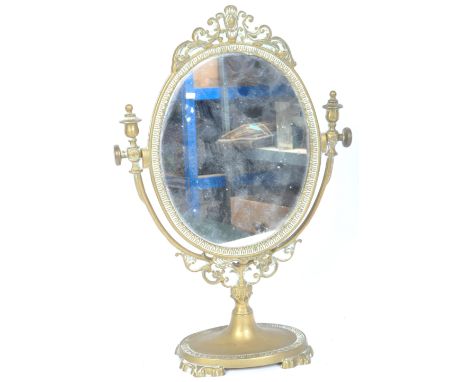 A vintage 20th century gilt metal adjustable dressing table mirror of oval form upon an oval plinth base with rococo manner r