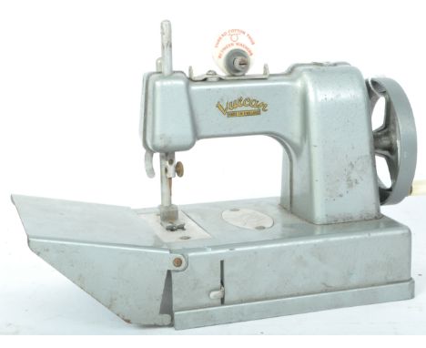 A vintage retro 20th century Vulcan miniature portable sewing machine in a metallic grey colourway. Measures 27cm length.&nbs