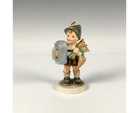 A figure of boy wearing traditional attire, holding a stein and bunch of radishes. M.I. Hummel impressed. Goebel backstamp. I