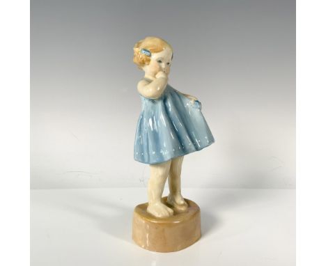 A young blonde girl in a charming blue dress adorned with white polka dots playfully holds out her dress, with her hand in he