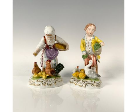 A boy in a bright yellow coat and red striped pants tends to his ducks, offering them fresh kale, while a girl dressed in a l
