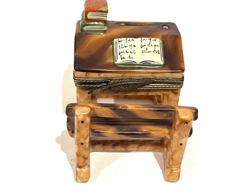 Exceptional faux bois hinged wood detailing make this stunning miniature so realistic. Books piled on its corner one open for