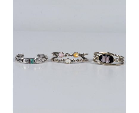 The fist bracelet tested sterling silver and has a turquoise stone. The second bracelet tested sterling silver and has three 
