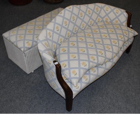 A 19th century mahogany framed small sofa recovered in floral fabric; and a Lloyd loom style blanket box upholstered to match