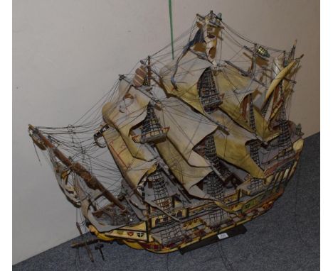 A wooden scale model of a twin-masted sailing ship 