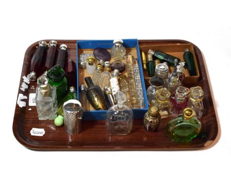 A tray of various glass and silver-mounted glass scent bottles and perfume bottles, including ruby glass, green glass and ame