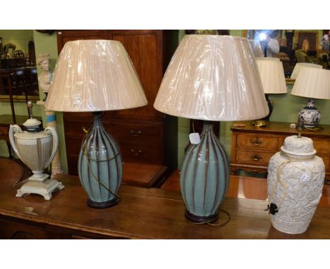 A pair of large green pottery table lamps with silk shades, and two other ceramic lamps (4)