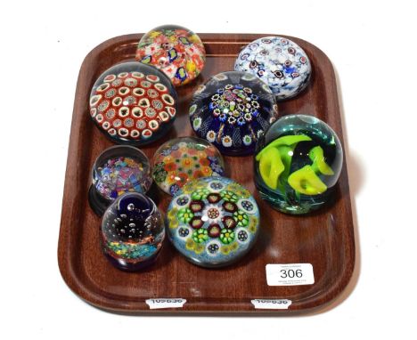 Nine various glass paperweights   Paper weight with yellow flowers has several chips, some to the top. Paperweight with stand