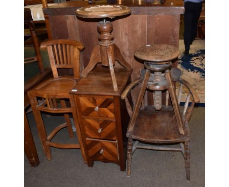 A German secession tall bar chair; two tripod stools; an open tub chair; and a small three height chest of drawers 
