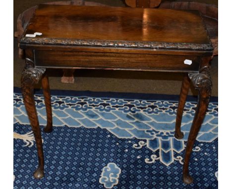 A mahogany fold over card table, green baize inset, carved cabriole legs