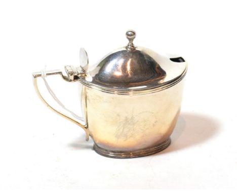 A George III silver mustard-pot, by John Emes, London, 1802, tapering oval and with reeded rims, the hinged cover with ball f