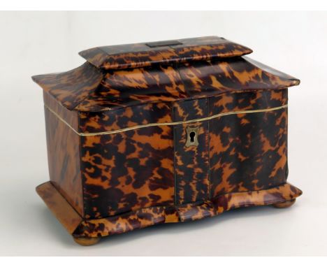 A 19th century blonde tortoiseshell  tea caddy, of serpentine outline, the domed hinged lid enclosing two lidded compartments