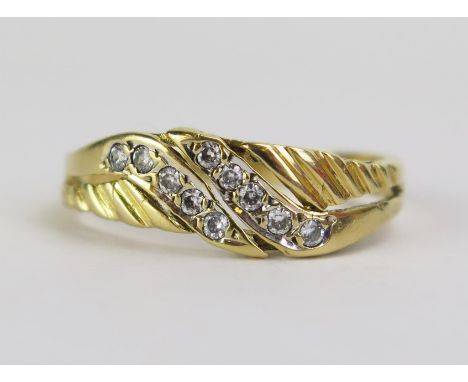 An 18ct Gold and Diamond Dress Ring, set with ten c. c. 1.2mm stones, stamped 18CT, size O, 2.78g 