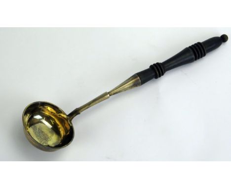 An Imperial Russian silver ladle, bears kokoshnik mark, with gilded oval bowl with floral decoration to the underside, on a r