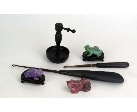 Three assorted polished agate models of frogs, two with polished wood stands, an ebonised ring tree and two button hooks. 