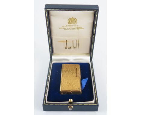 A gold plated Dunhill 70 lighter, with bark design, cased. 