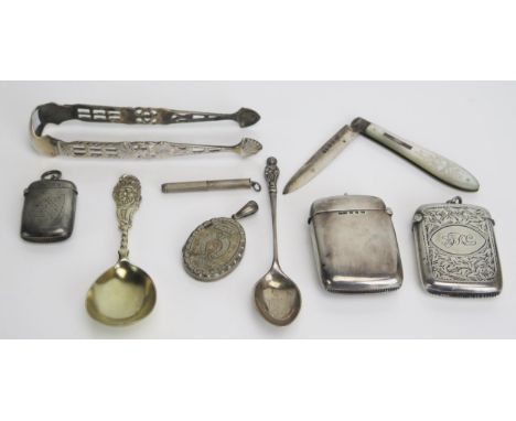 A mixed collection of silver wares various makers and dates includes three vesta cases, caddy spoons, sugar tongs, fruit knif